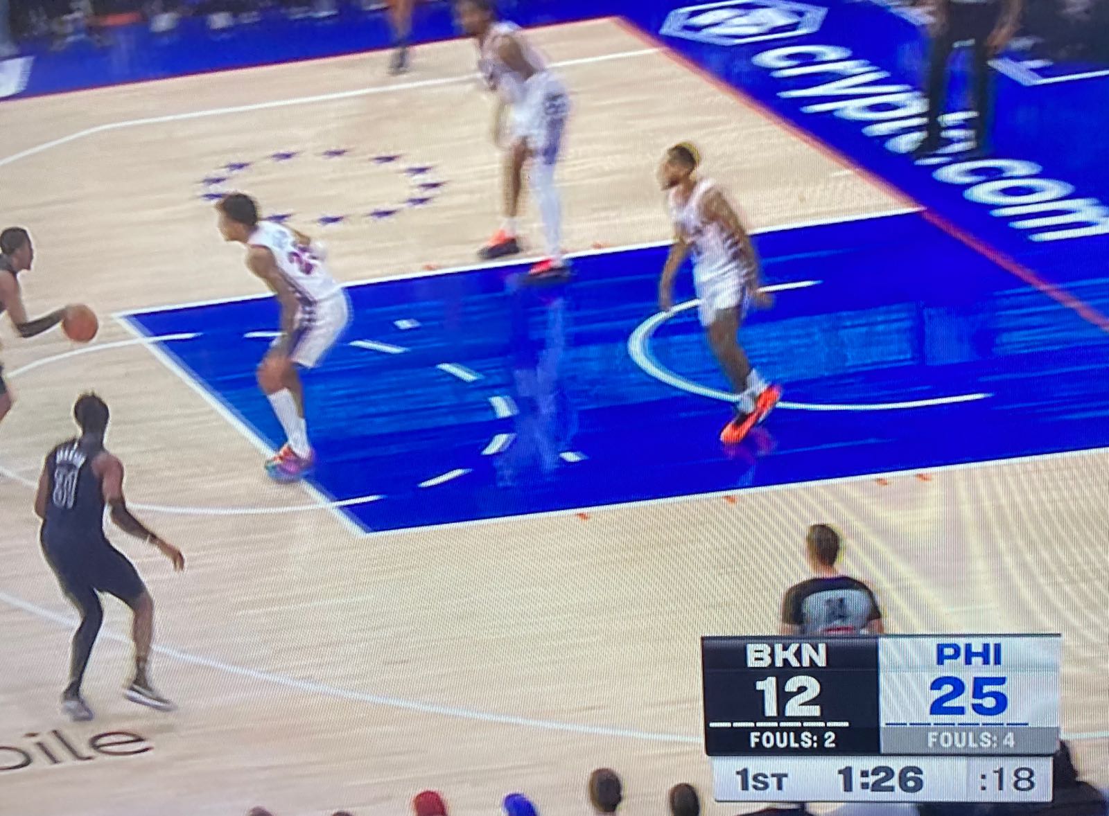 photo of a tv set showing a baseketball game between brooklyn and the philadelphia cropped to make the score bug prominent