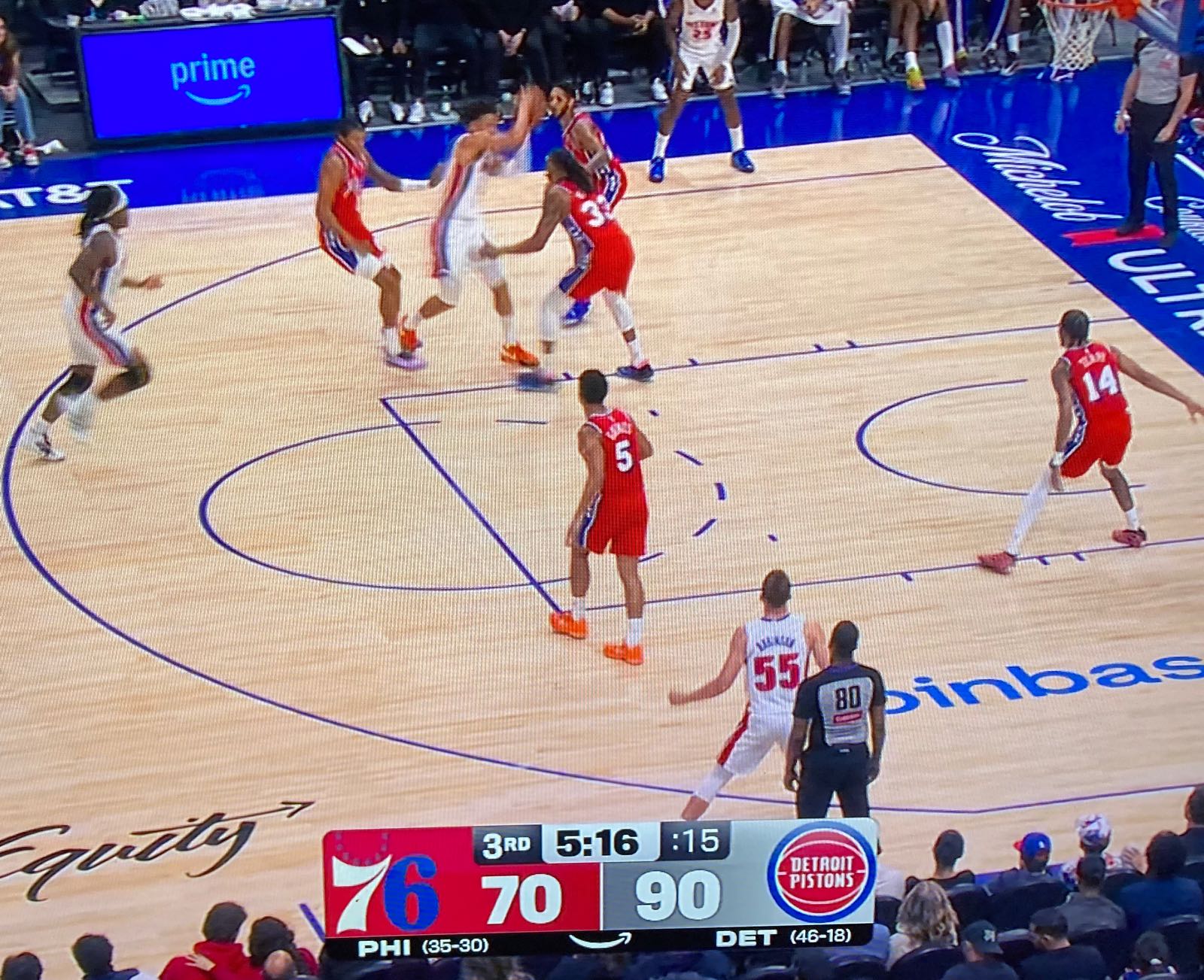 photo of a tv set showing a baseketball game between the 76ers and the pistons cropped to make the score bug prominent